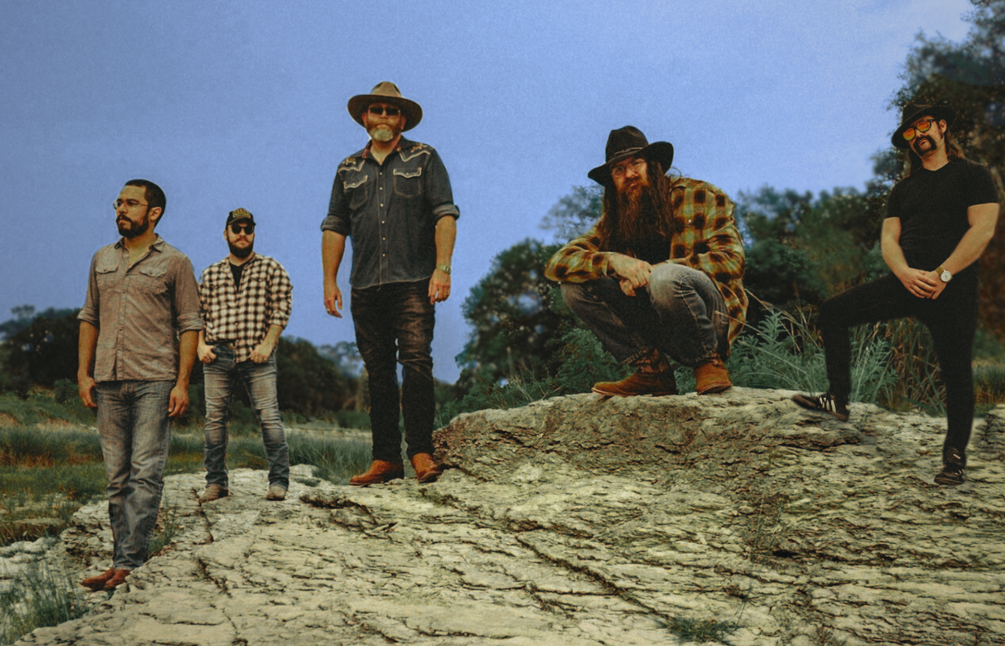 Band standing on uneven rocks